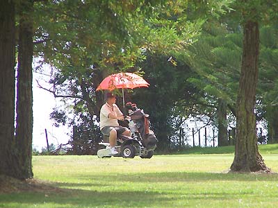 One person riding golf cart