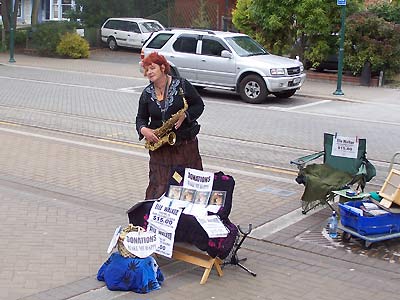 Woman playing for cash at the Sunday market