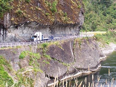 Large truck on a one-lane road carved out of the side of a mountain